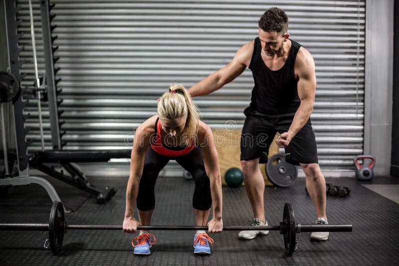 Trainer Helping Woman With Lifting Barbell Stock Image Image Of