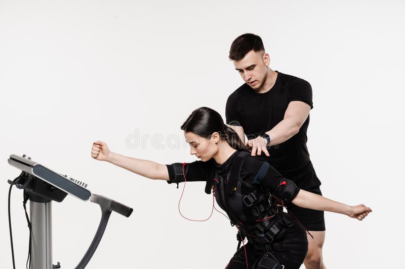 Trainer Shows an Example of the Exercise Using EMS Electrical Muscle