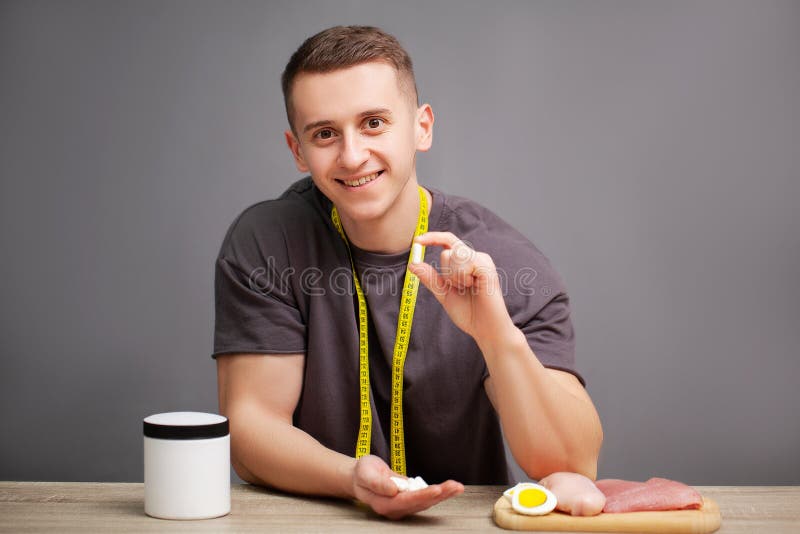 Trainer Takes a Pill of Amino Acids after Training Stock Photo Image