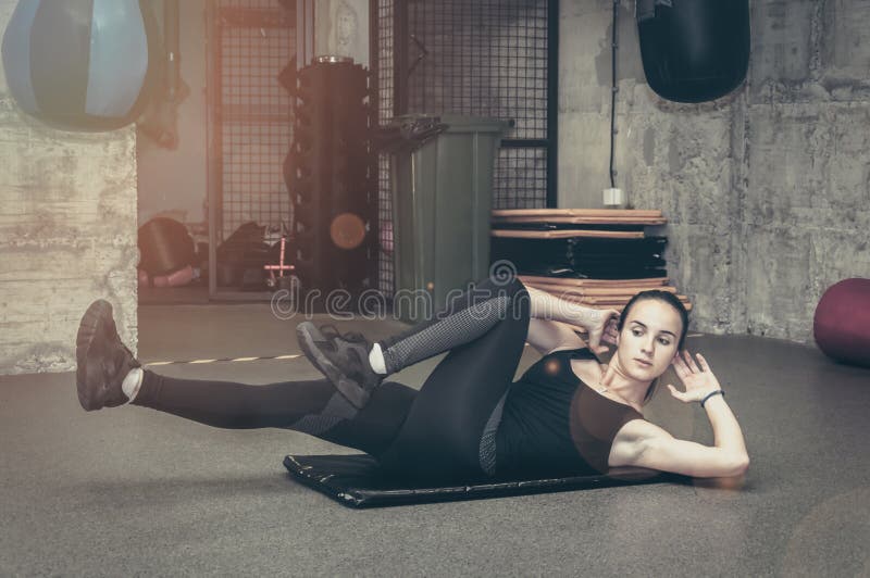 Training of beautiful attractive young girl workout abs muscles in the boxing gym royalty free stock photo Training of beautiful attractive young girl workout abs muscles in the boxing gym royalty free stock photo