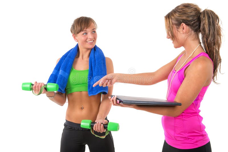Premium Photo  Female personal trainer helping woman doing exercises in  the gym.