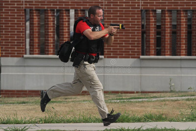 A police officers carries a drawn handgun during an active shooter training session on Aug. 4, 2018, in Indianola, Iowa, USA. A police officers carries a drawn handgun during an active shooter training session on Aug. 4, 2018, in Indianola, Iowa, USA