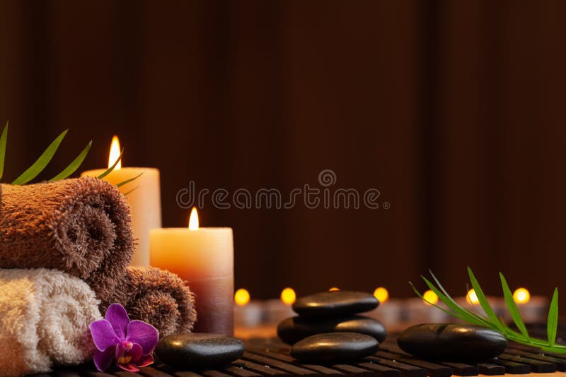 Aromatherapy, spa, beauty treatment and wellness background with massage stone, orchid flowers, towels and candles. Aromatherapy, spa, beauty treatment and wellness background with massage stone, orchid flowers, towels and candles