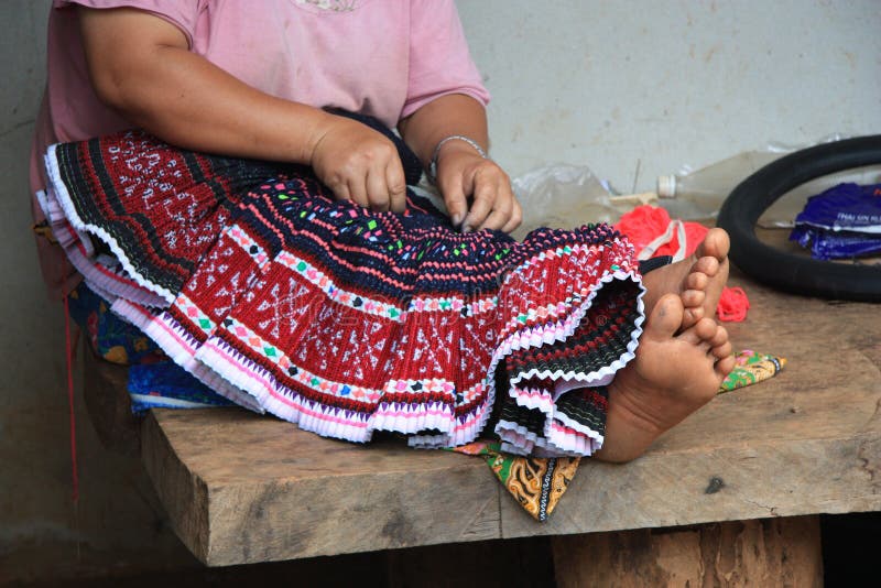 Karen minority woman sewing festive ethnic dress, Northern Thailand. Karen minority woman sewing festive ethnic dress, Northern Thailand