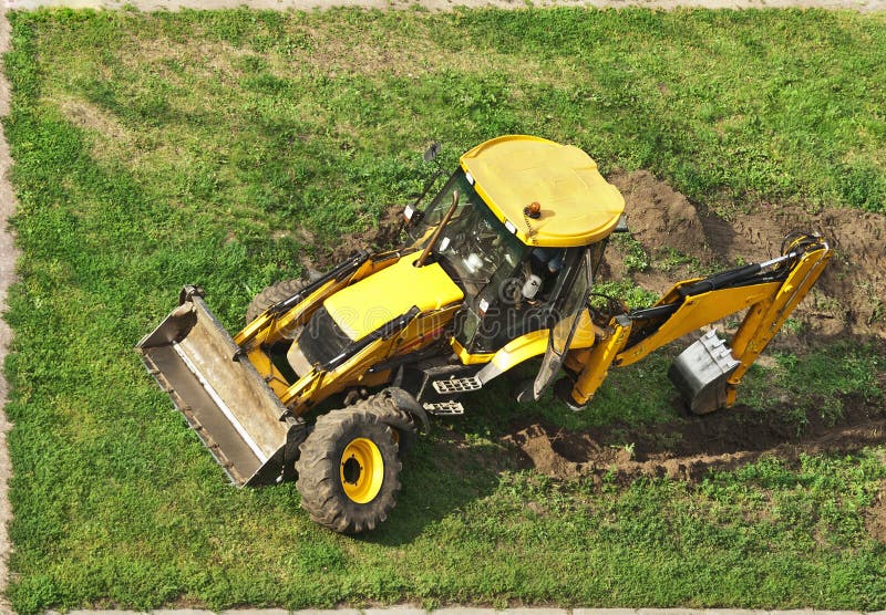 Tractor without wheel on grass-lawn. Tractor without wheel on grass-lawn