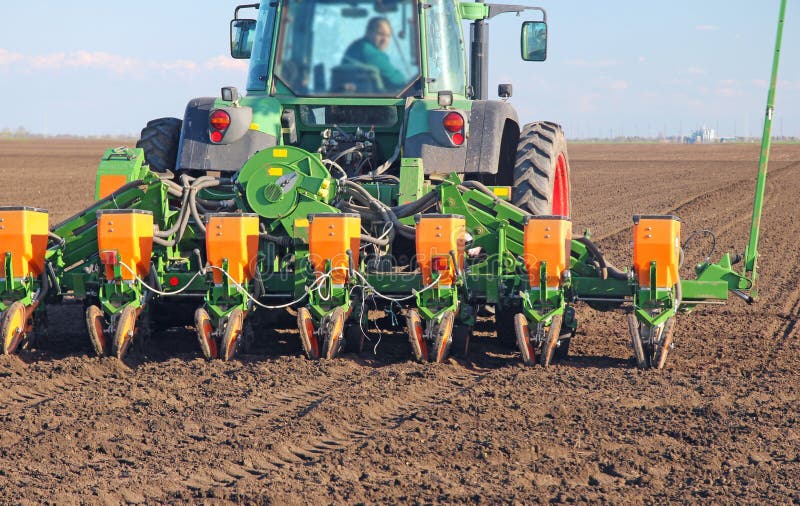 Agricultural tractor sowing and cultivating field. Agricultural tractor sowing and cultivating field