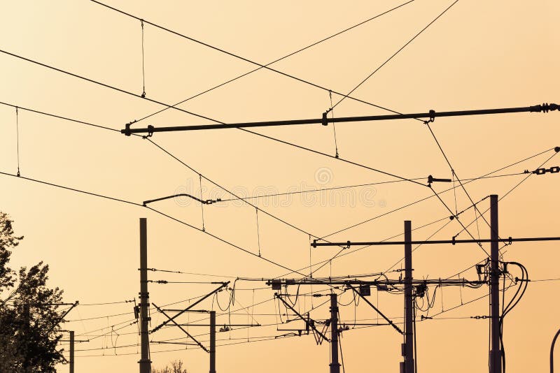 Tram  cables at sundown.Tramway overhead traction photo. Electric, transport wires photography.  Transportation infrastructure at sunset in downtown . Urban traffic wire structure