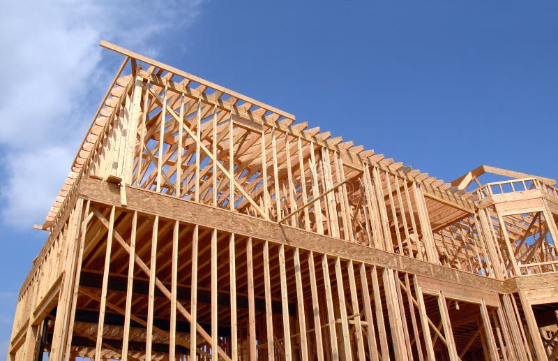 House being built in wooden frame against a blue sky. House being built in wooden frame against a blue sky