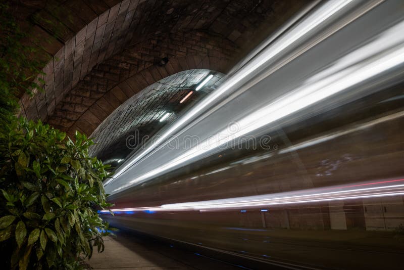 Tramway Tunnel at Night with Tram Light Trails