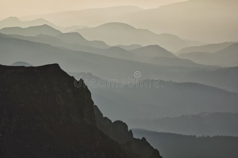 Misty Layers of Rolling Hills Under a Soft Golden Sky
