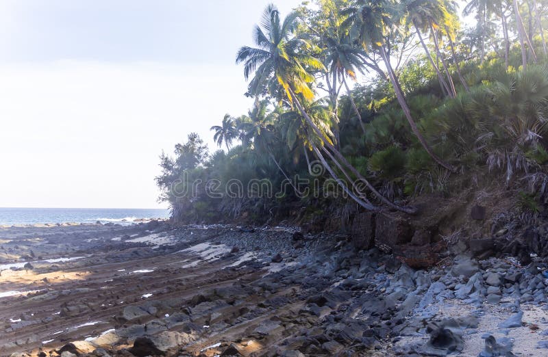 Tranquil sea coast view with rocky shore and infinite horizon during evening glow stock photography