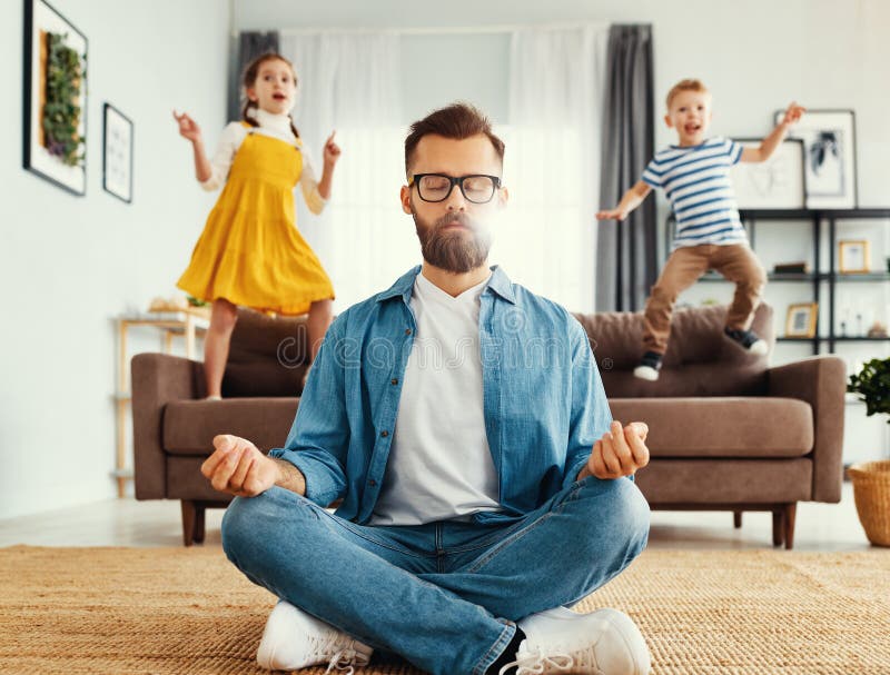 Father meditating in room with playful kids stock photos Father meditating in room with playful kids stock photos