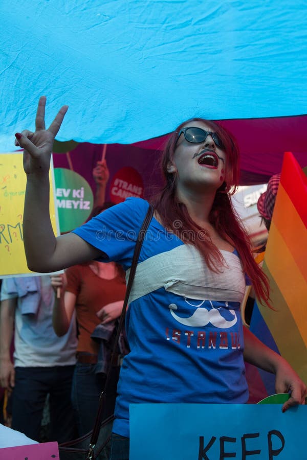 ISTANBUL, TURKEY - JUNE 22, 2014: Girl in 5. Trans Pride March held in Istiklal Avenue, Istanbul. Thousands of people gathered to celebrate begining of LGBT Honor week. ISTANBUL, TURKEY - JUNE 22, 2014: Girl in 5. Trans Pride March held in Istiklal Avenue, Istanbul. Thousands of people gathered to celebrate begining of LGBT Honor week.