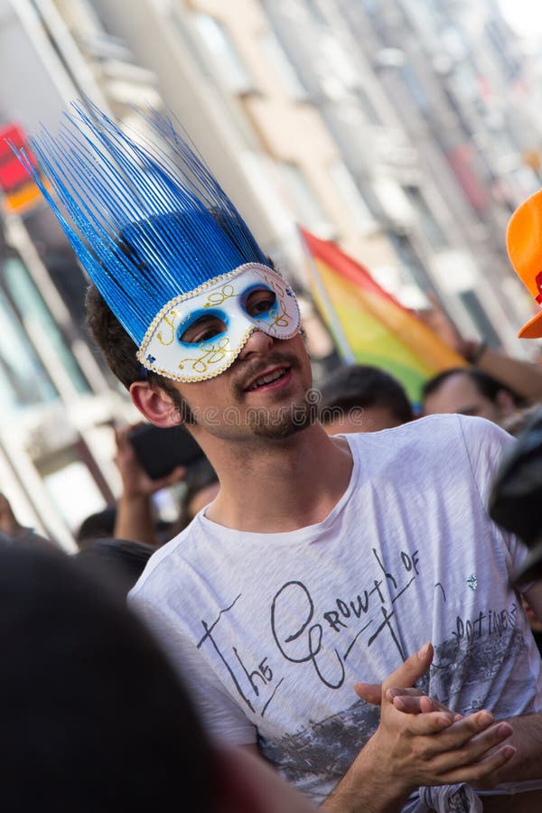 ISTANBUL, TURKEY - JUNE 22, 2014: Man with mask in 5. Trans Pride March held in Istiklal Avenue, Istanbul. Thousands of people gathered to celebrate begining of LGBT Honor week. ISTANBUL, TURKEY - JUNE 22, 2014: Man with mask in 5. Trans Pride March held in Istiklal Avenue, Istanbul. Thousands of people gathered to celebrate begining of LGBT Honor week.