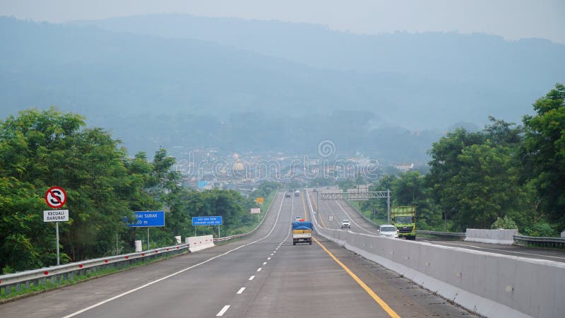 Trans Java toll road during the day, downhill road, faint background of hills stock images
