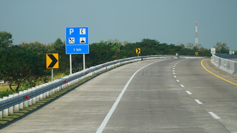 Trans Java toll road at noon. There is a rest area information board stock image