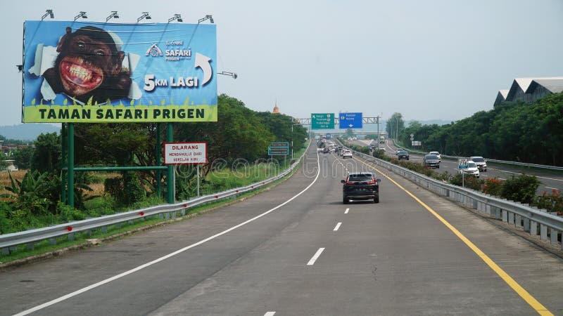 Trans Java toll road with a Prigen Safari Park advertising board on the side of the road royalty free stock photo