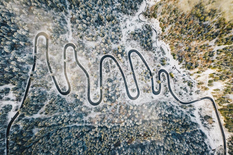 Transalpina mountain road in the forest in winter time. Winter winding road shot using a high resolution drone. Transalpina stock images, royalty-free photos and pictures