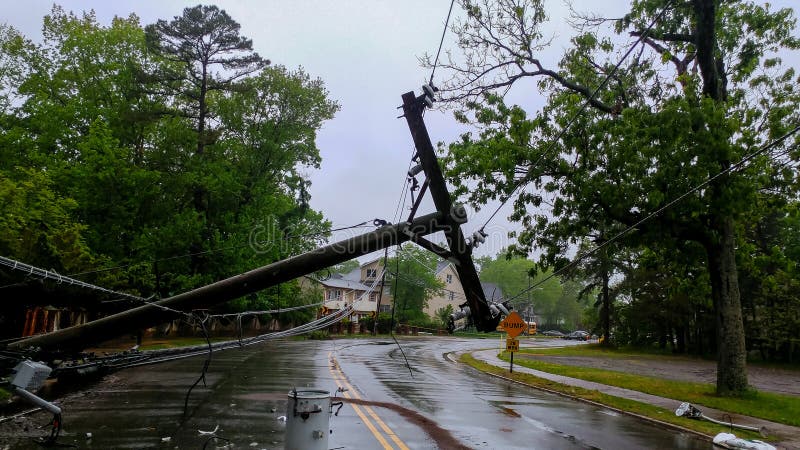 Transformer on a pole and a tree laying across power lines over a road after Hurricane moved across royalty free stock image