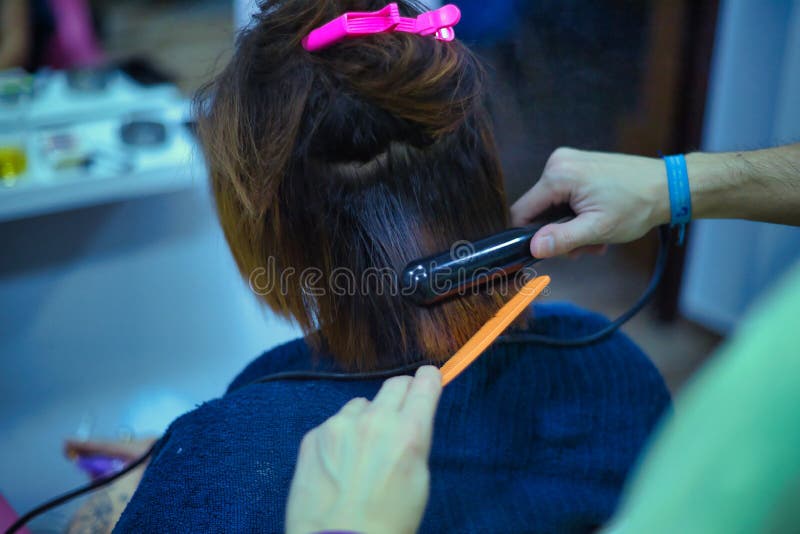 Transgender Woman Ironing Her Hair with a Hair Straightener during a  Keratin Treatment at a Hair Salon. Transgender Concept, Stock Photo - Image  of lgbt, diversity: 235551818