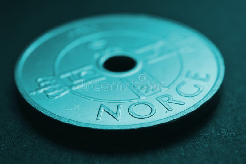 Translation: Norway. 1 Norwegian krone coin close up. National currency of Norway. Teal tinted money background for news about economy or finance. Loan and credit. Tax and inflation. Macro