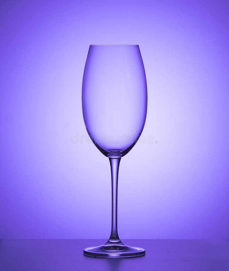 Empty wine glass on a purple background. close up. royalty free stock photos Empty wine glass on a purple background. close up. royalty free stock photos