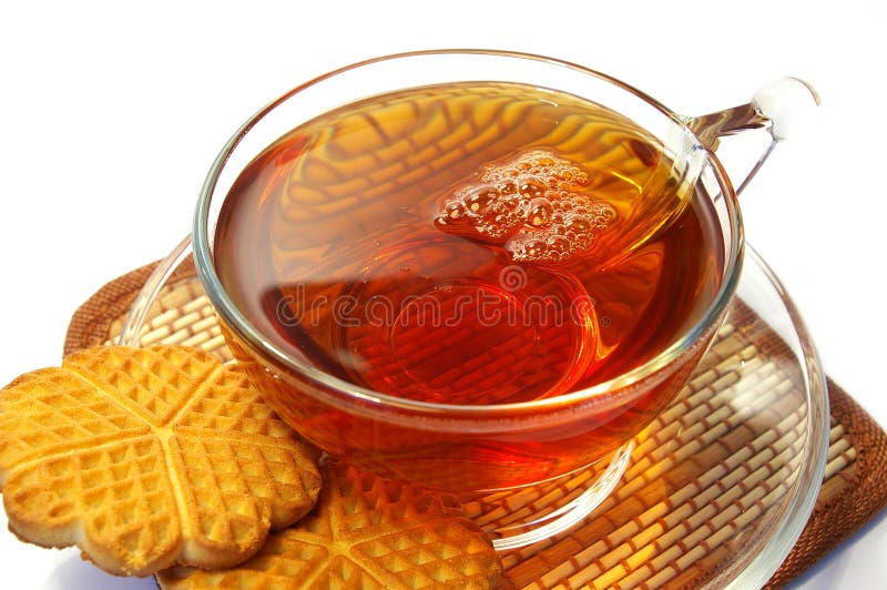 Transparent cup of tea and cookies