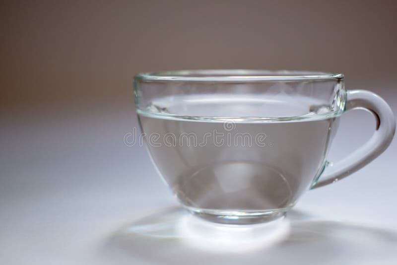 Four Beautiful Glass Cup Filled With Water In Blue Stock Photo, Picture and  Royalty Free Image. Image 8160433.