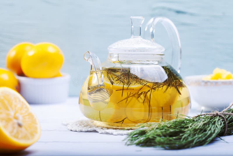 Glass teapot with herbal tea and lemon. Borosilicate glass teapot with spiral strainer