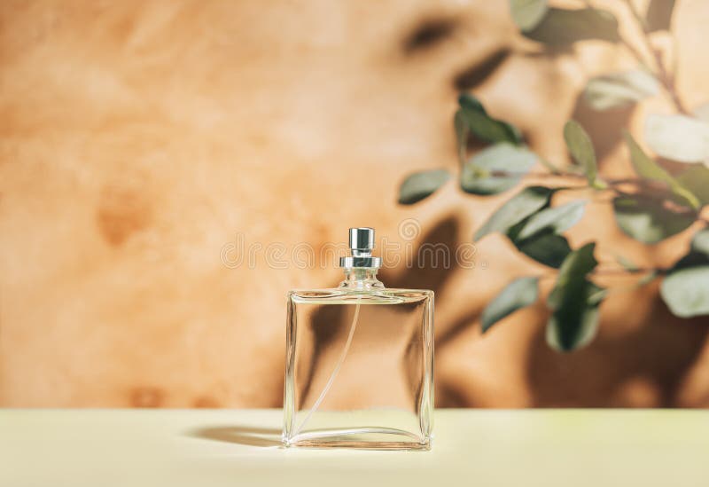 Transparent perfume bottle on a mediterranean style background. stock photo