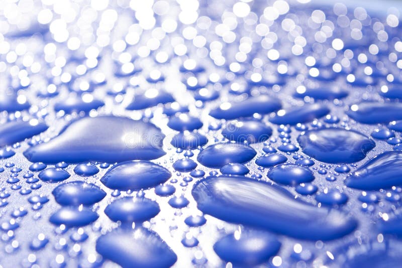 Transparent Still Water Drops on Light Blue Background. Blue Water