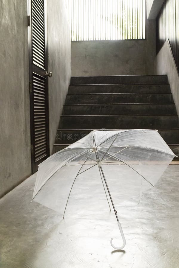 Transparent Umbrella on Floor with Cement Stair Step Stock Image