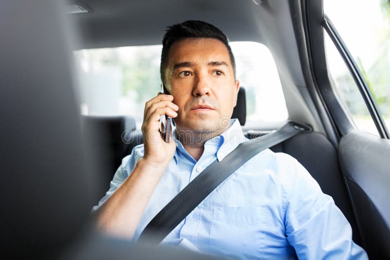 Male passenger calling on smartphone in taxi car royalty free stock photos Male passenger calling on smartphone in taxi car royalty free stock photos
