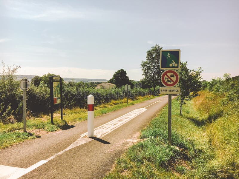 Transport and roads in the france region of the burgundy. Bicycle route, service road in rural areas in summer. Road signs and war royalty free stock image Transport and roads in the france region of the burgundy. Bicycle route, service road in rural areas in summer. Road signs and war royalty free stock image