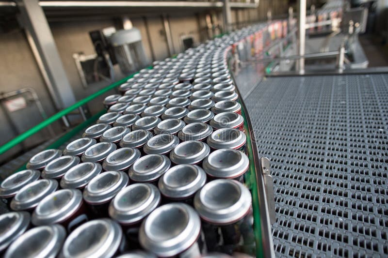 Stain-roof jars with drinks on the assembly line. for the production of alcoholic and soft drinks line. The final stage in the manufacture of the product. Stain-roof jars with drinks on the assembly line. for the production of alcoholic and soft drinks line. The final stage in the manufacture of the product.