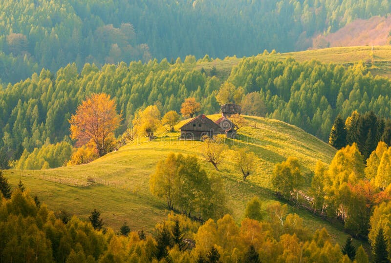 Transylvania Autumn landscape at sunrise - Romanian traditional house on a hill in the forest stock photo Transylvania Autumn landscape at sunrise - Romanian traditional house on a hill in the forest stock photo