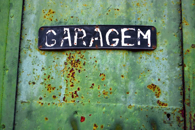 Close up of rusty green garage door showing rust and peeling paint. Close up of rusty green garage door showing rust and peeling paint.