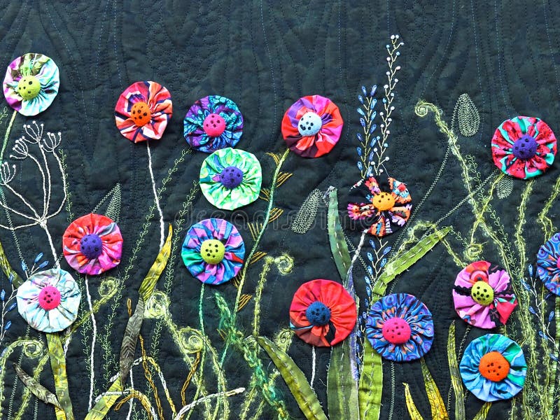 Quilt with brightly coloured `yoyo` flowers against a black background at the Festival of Edmonton Quilts June 1, 2019. Quilt with brightly coloured `yoyo` flowers against a black background at the Festival of Edmonton Quilts June 1, 2019