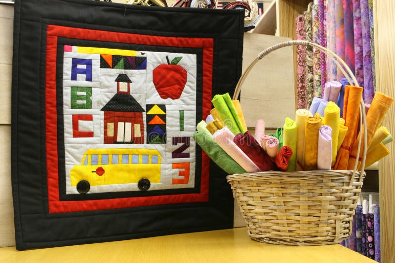 School days quilt with basket of colorful cloth to purchase for quilting. School days quilt with basket of colorful cloth to purchase for quilting