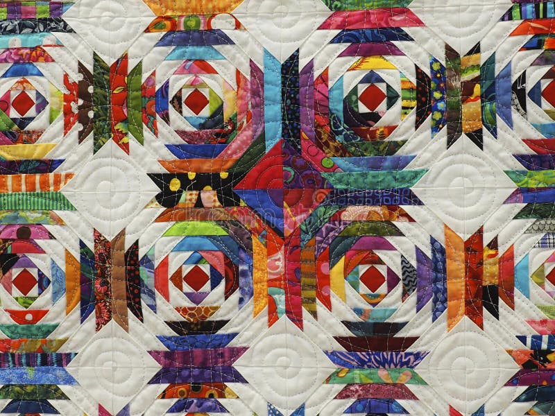 Colourful traditional quilt with brightly coloured fabric  against a white backgroundat the Festival of Edmonton Quilts June 1, 2019. Colourful traditional quilt with brightly coloured fabric  against a white backgroundat the Festival of Edmonton Quilts June 1, 2019