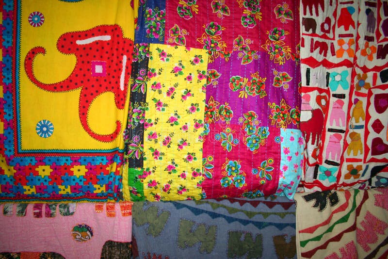 Colorful handmade quilts hanging at a bazaar. Colorful handmade quilts hanging at a bazaar