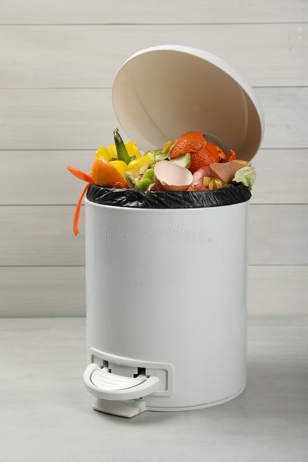 Trash Bin with Organic Waste for Composting on Light Background Stock