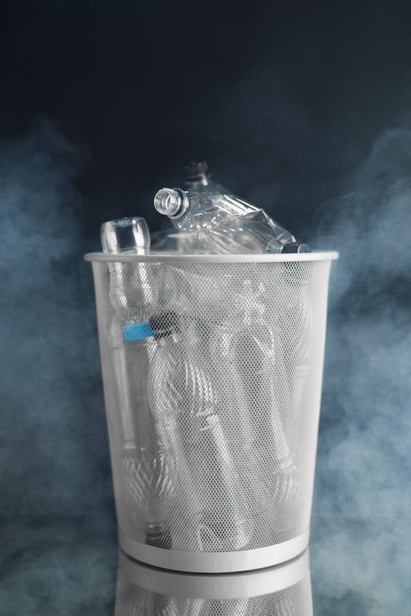 Trash Can with Wasted Plastic Bottles, Smoke Background, Pollution