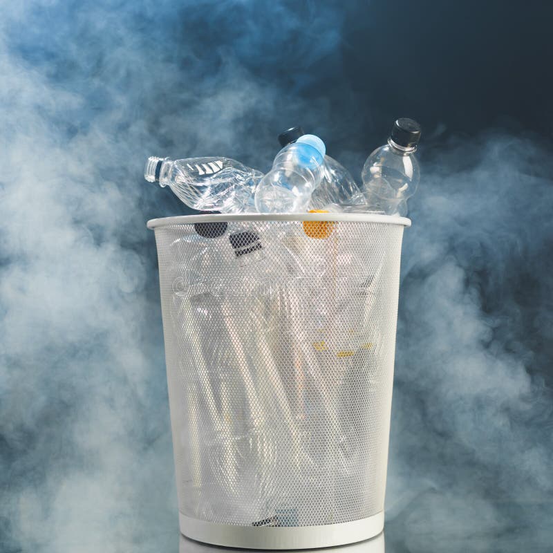 Trash Can with Wasted Plastic Bottles, Smoke Background, Pollution