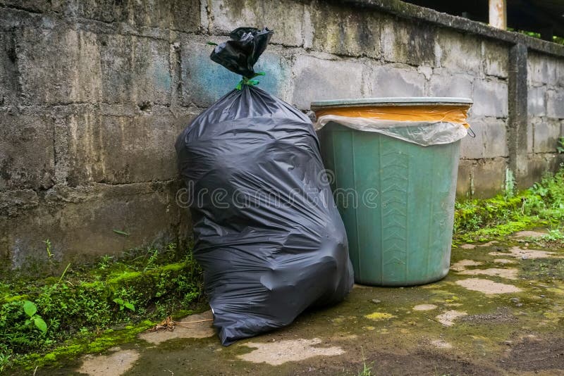 Trash Cans and Black Plastic Bags Filled with Trash Stock Photo Image