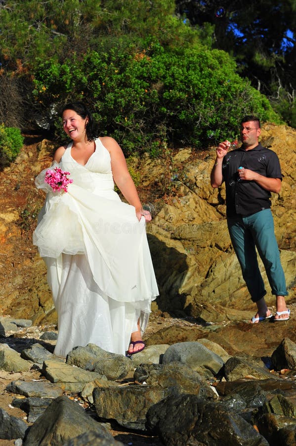 Trash el vestido - los BU que soplan felices de novia y del novio imagen de archivo Trash el vestido - los BU que soplan felices de novia y del novio imagen de archivo