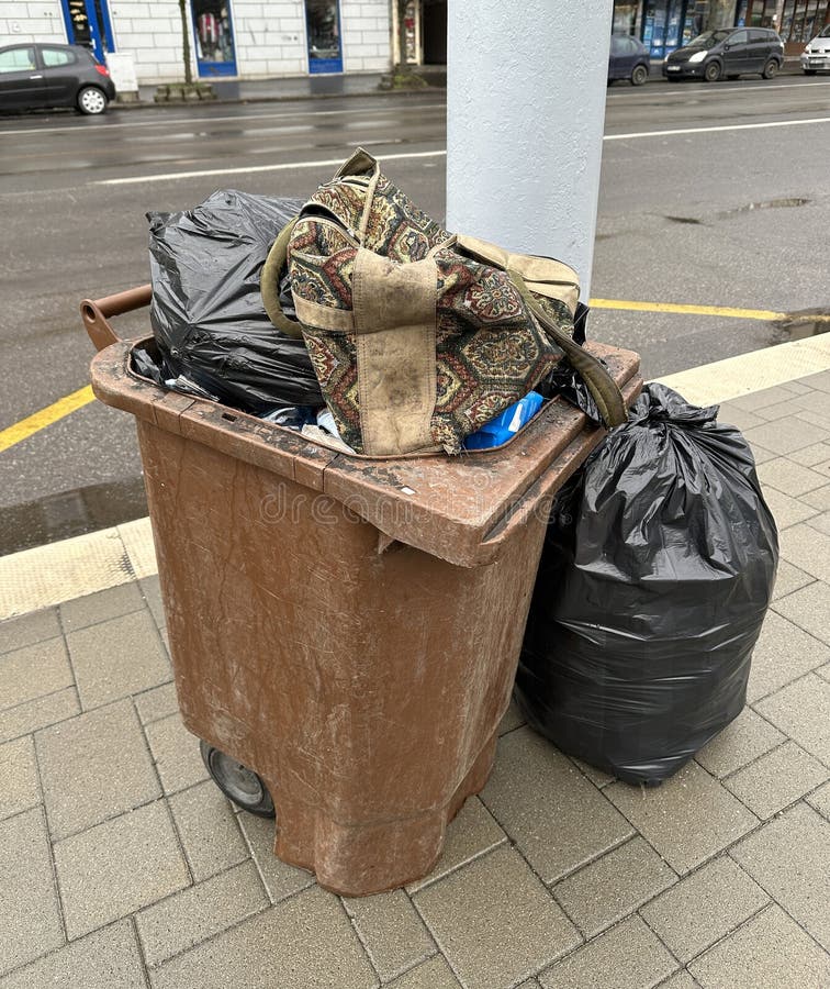 Trashcan on the street full of garbage royalty free stock photography