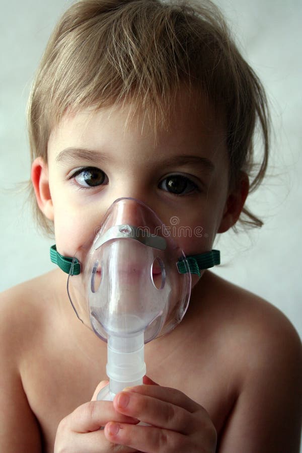 A little girl looks sad as she takes her nebulizer breathing treatment. A little girl looks sad as she takes her nebulizer breathing treatment.