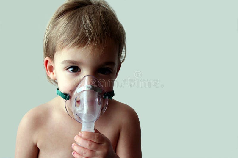 A little girl looks sad as she takes a nebulizer breathing treatment. There is room to the right of the subject for text. A little girl looks sad as she takes a nebulizer breathing treatment. There is room to the right of the subject for text.