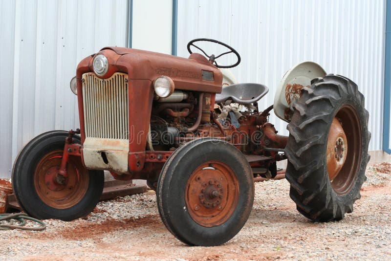 Antique tractor by a building. Antique tractor by a building